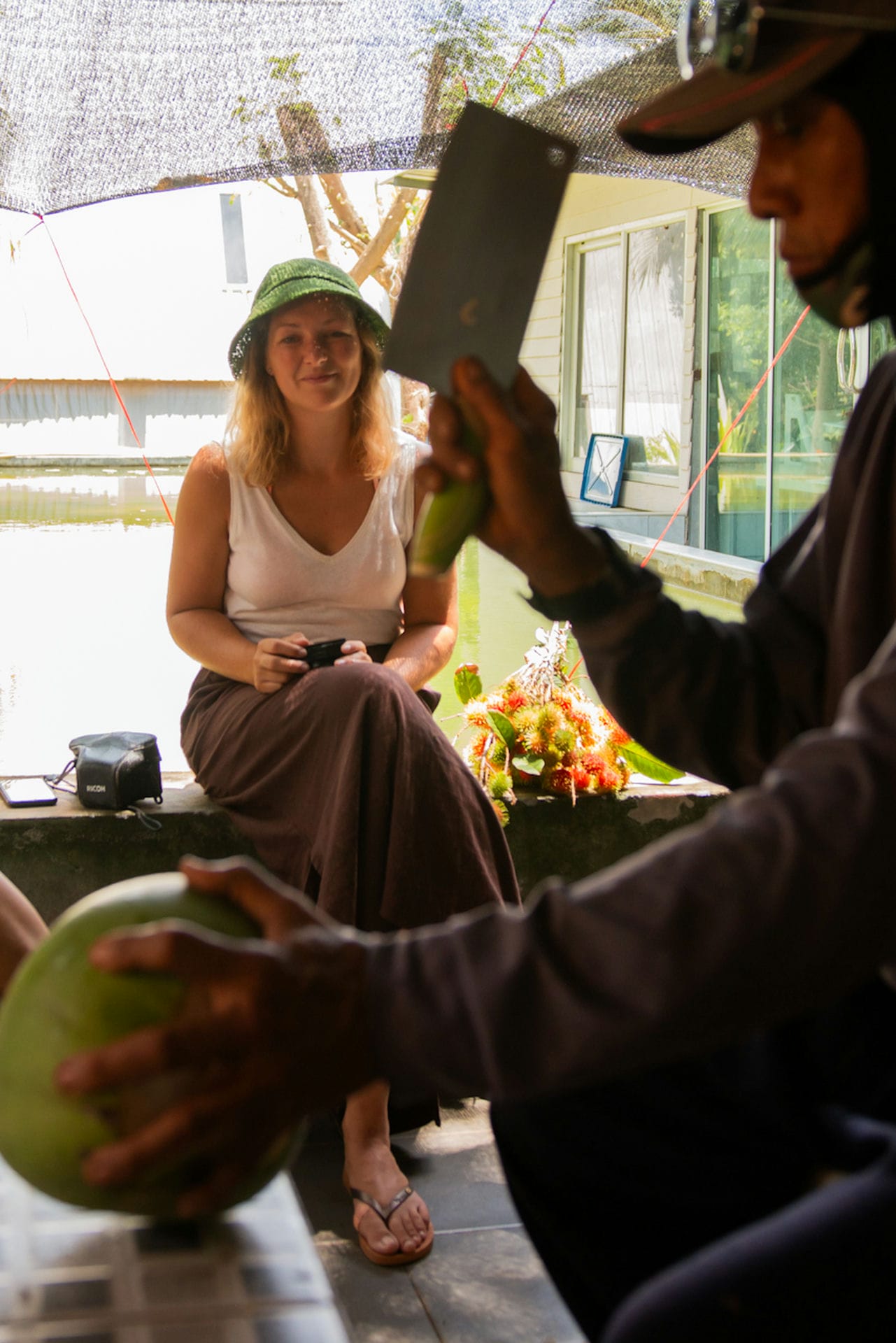 Man cutting coconut for us to drink